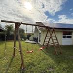 Backyard with playground equipment and solar panels on the roof