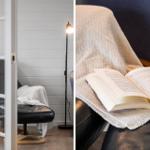A room with white walls, a black chair, and a floor lamp. A book rests on a cover.