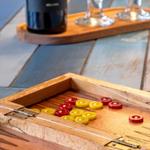 Wooden box with backgammon pieces and wine on wooden table