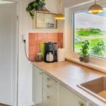Kitchen with countertop, sink, and view of green areas