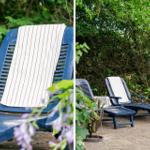 Two blue lounge chairs with towels in the garden, surrounded by greenery and flowers.