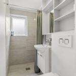 Bathroom with sink, shower, and window