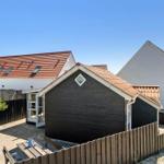 Wooden house with terrace and garden fence. Backyard with table and chairs.