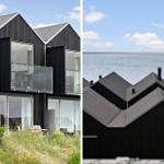 Moderne schwarze Ferienhäuser mit Balkonen und Meerblick.
