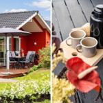 Red vacation house with terrace and garden. On the table are two mugs and a thermos.