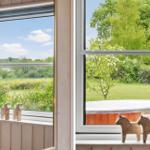 Through the window, you see a garden with a hot tub and trees.