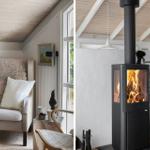 An armchair with cushions and a blanket next to a window. A fireplace with burning wood.
