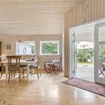 Bright room with dining area, hardwood floor, and view to the terrace.