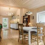 Dining room with table, chairs, and view into the kitchen.