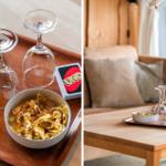 Essbereich mit Tisch und Stühlen unter Holzdecke mit Dachfenstern. Küche und Sofa im Hintergrund.