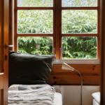 Through open door, view of green grass and leafless trees.