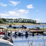 Boat harbor with boats and cyclist by the water