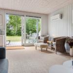 Living room with sliding doors to the terrace, two chairs and a sofa.