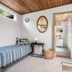 Bedroom with bed, mirror, and entrance to the bathroom.