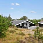 Apartment with kitchen, bathroom, three bedrooms, and two sheds.