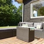 House with terrace, seating area, and fire pit in the garden