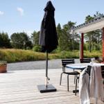Deck with table and two chairs with checkered cushions.