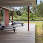 Sauna with wooden walls, bench, and bucket with wooden sticks.