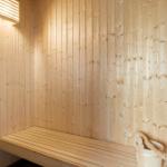 Entrance area with white cabinets, wooden wall, and door to outdoor space.