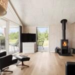 Kitchen with dining area, wood wall, and fireplace