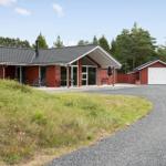 Large living and dining area with wood wall, glass doors, and wood stove.