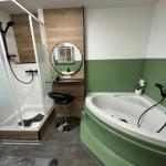Badezimmer mit Badewanne, Dusche und Kosmetikbereich